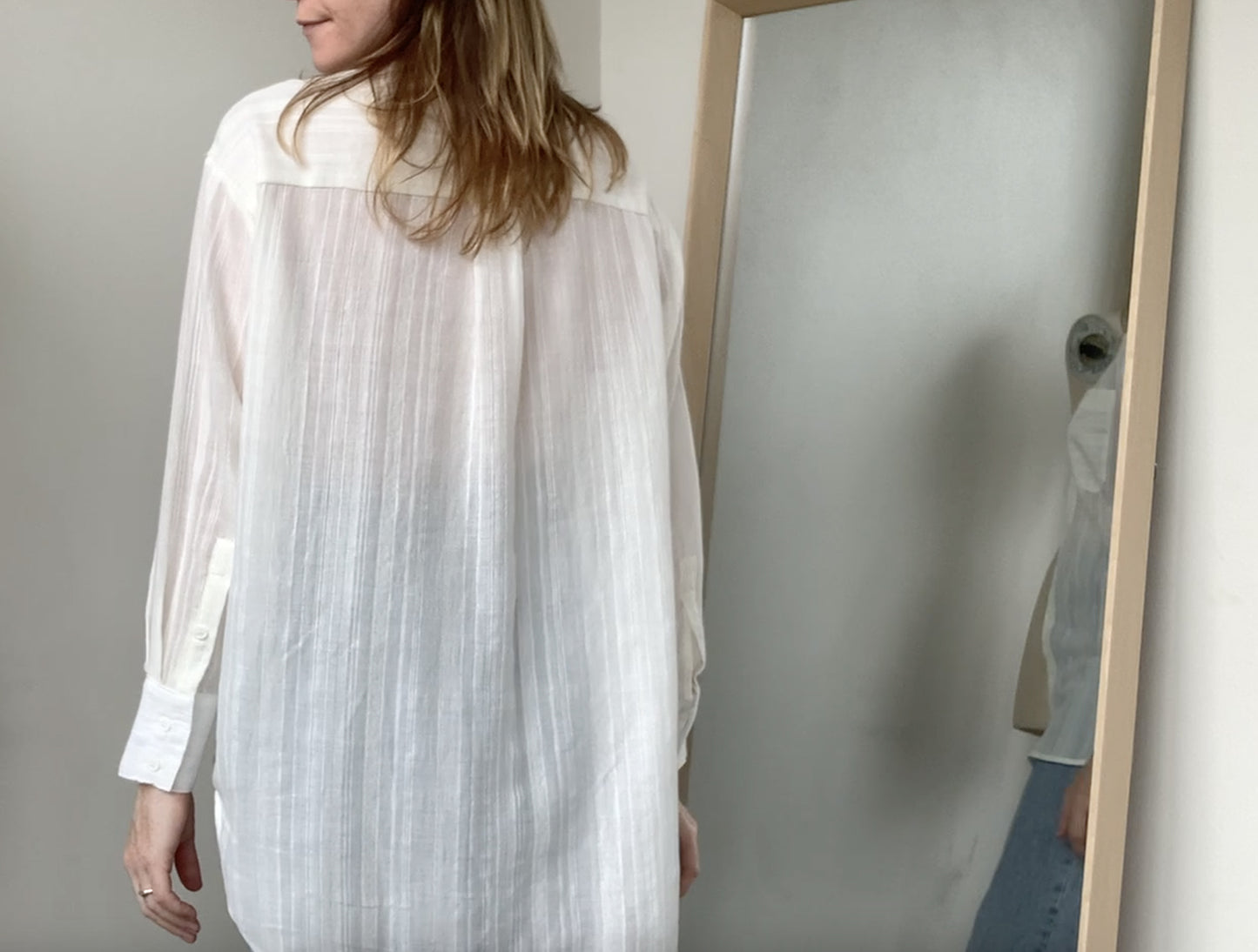 Model wearing CLIQD oversized shirt block - white, button up shirt with collar and box pleat on back.