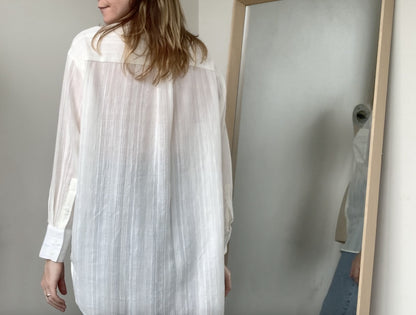 Model wearing CLIQD oversized shirt block - white, button up shirt with collar and box pleat on back.
