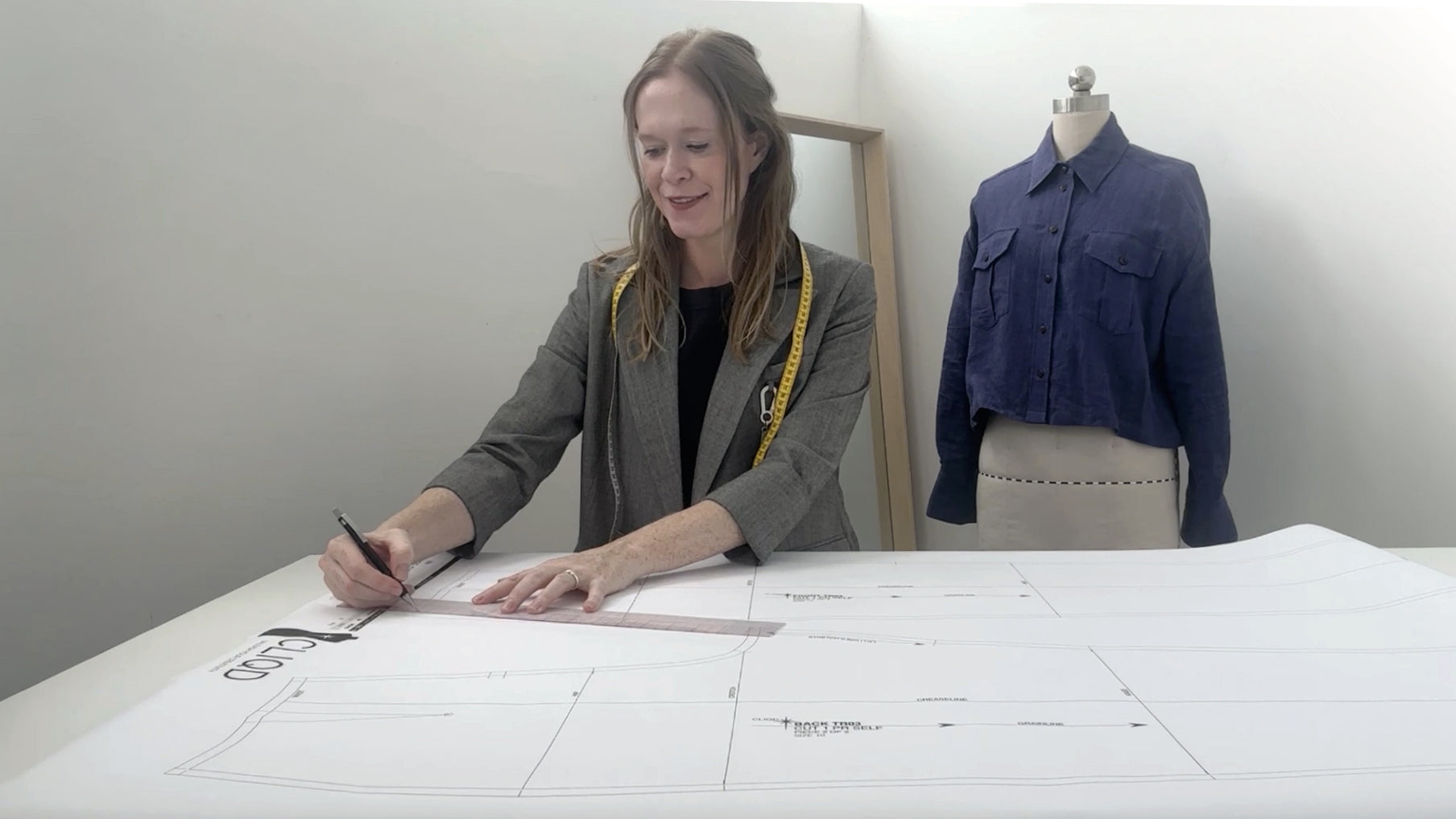 Leigh Goyen drafting a pattern block in her studio — CLIQD pattern drafting courses