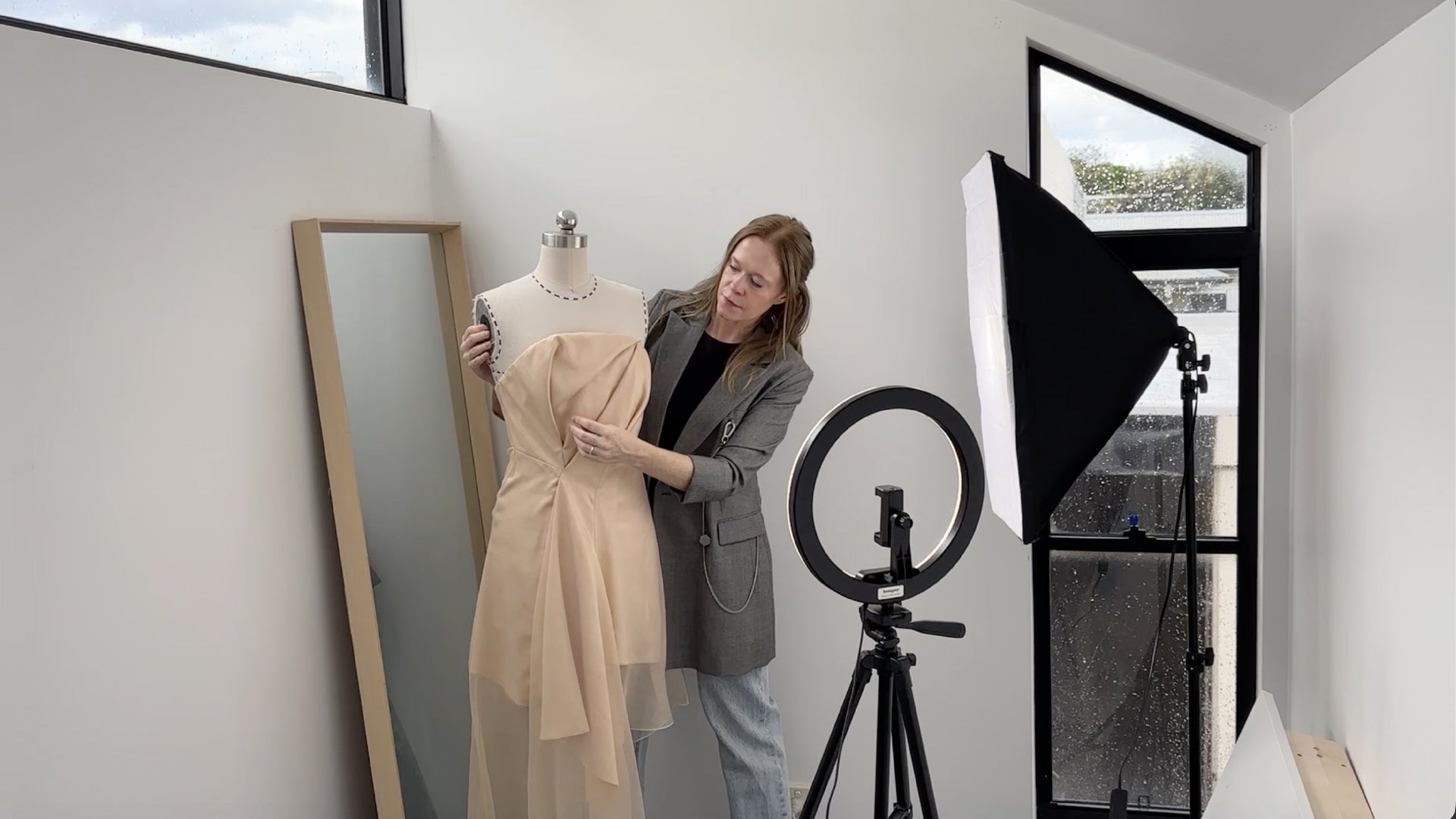 Leigh Goyen filming a pattern making tutorial for YouTube — draping a toile on a dress form in her studio
